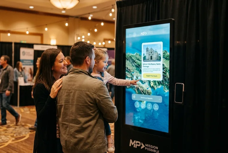 A girl taps the Mission Possible map on a 501KIOSK while her parents watch